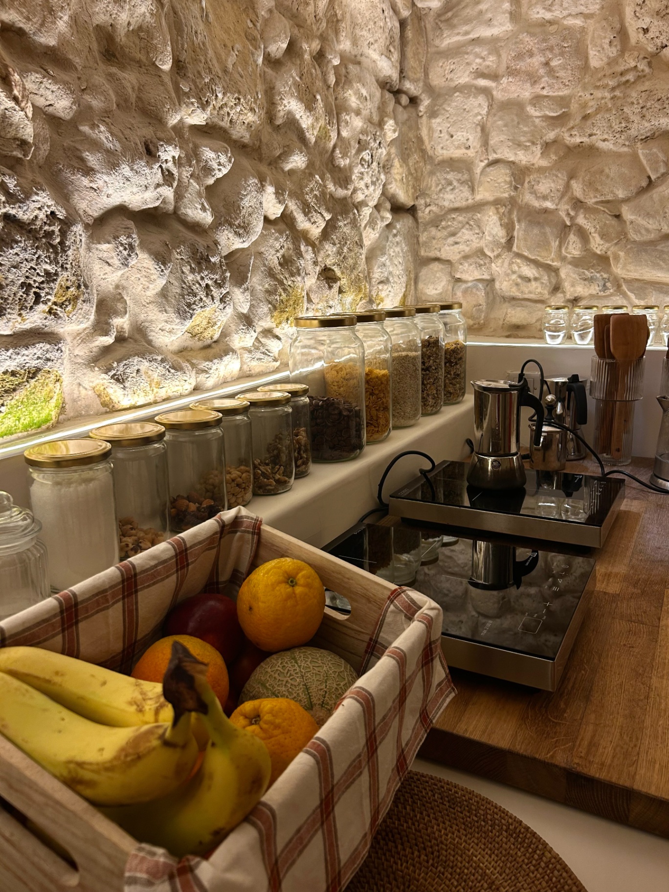 Shared pantry with jars of cereals, coffee and fresh fruit